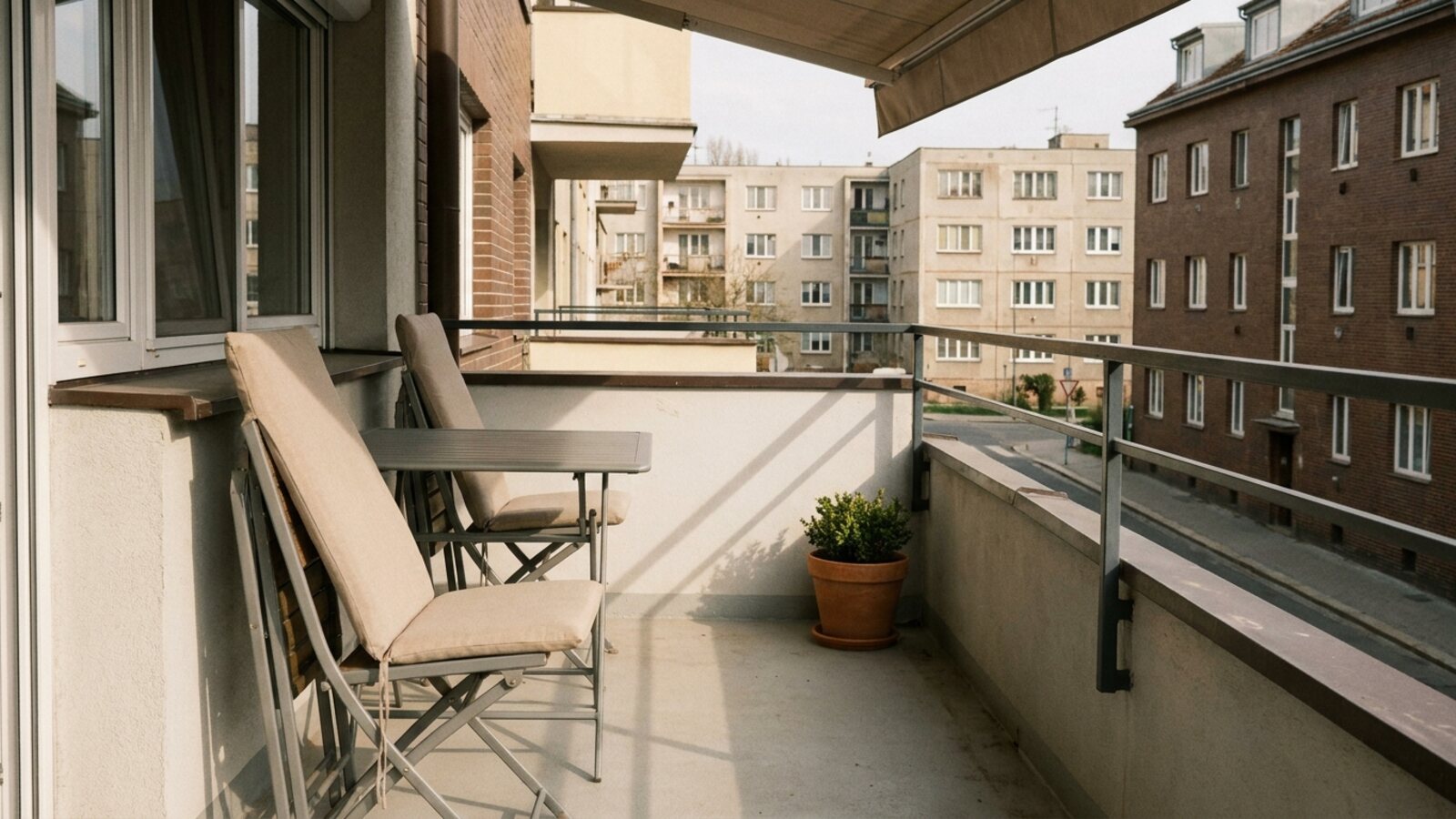 Freshly cleaned balcony furniture and cushions dry in the shade after spring cleaning.