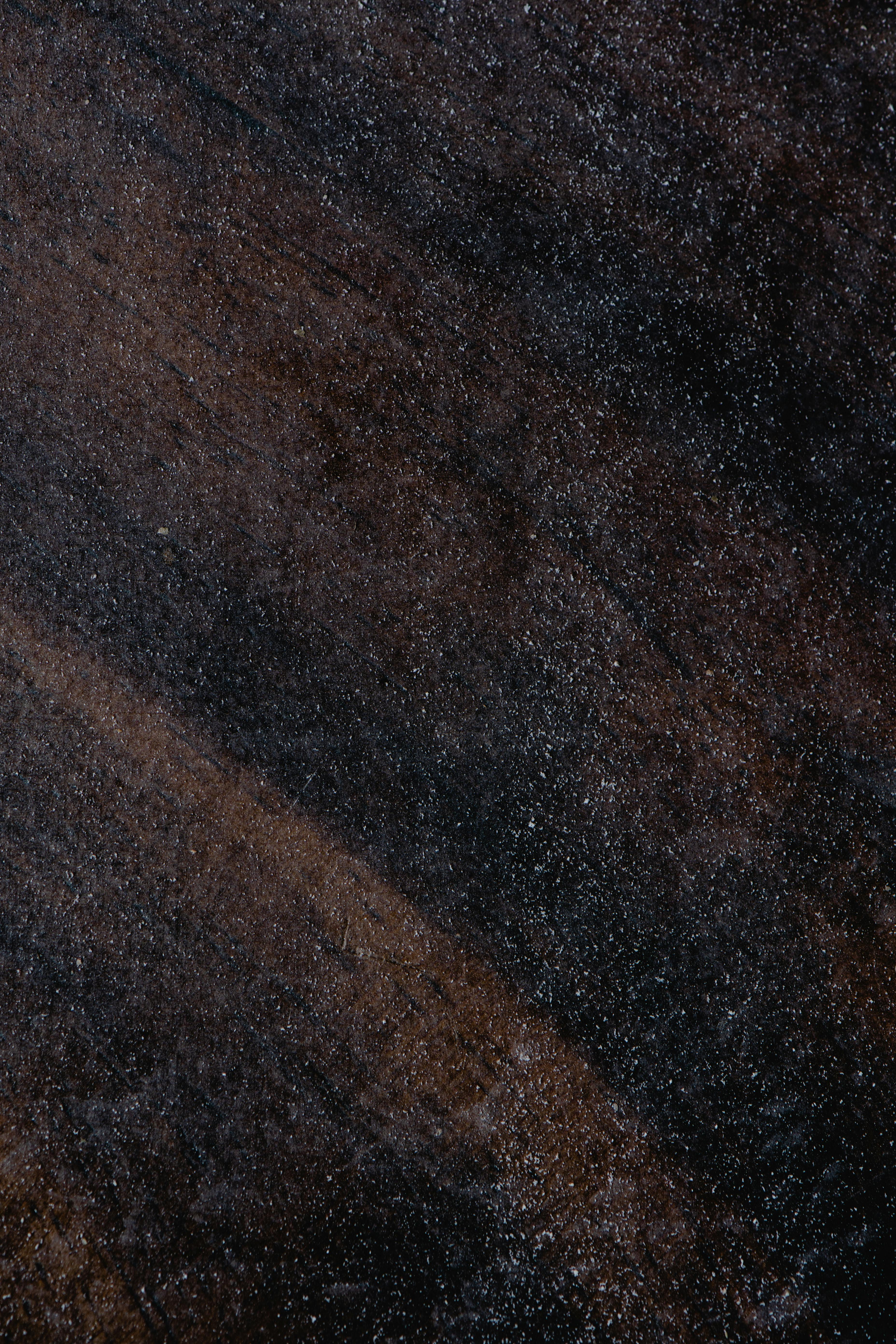 Macro shot of dust on a dark surface with a visible streak