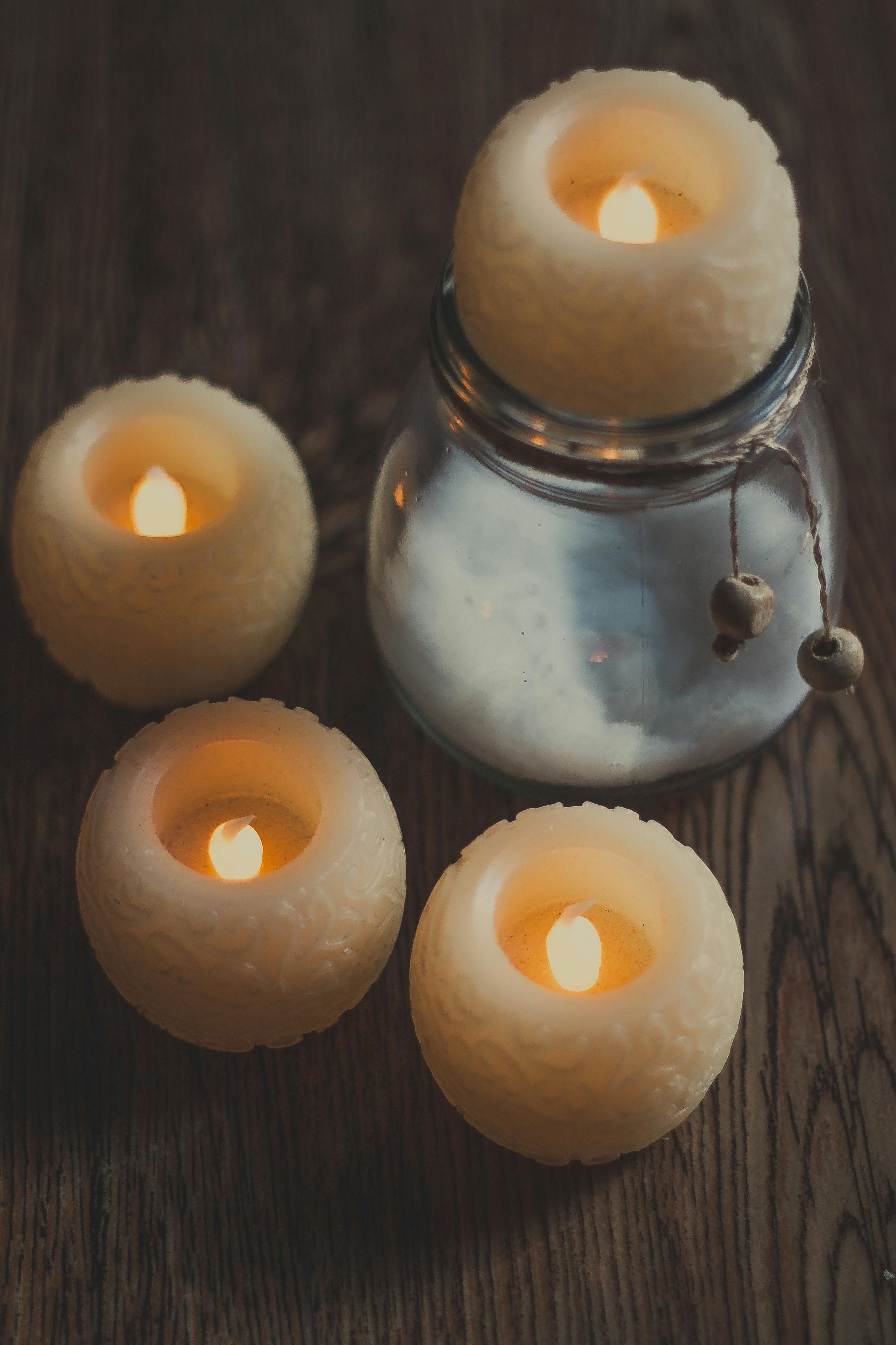 Candles on a wooden table as a reminder of wax and delicate surfaces after Easter decorations