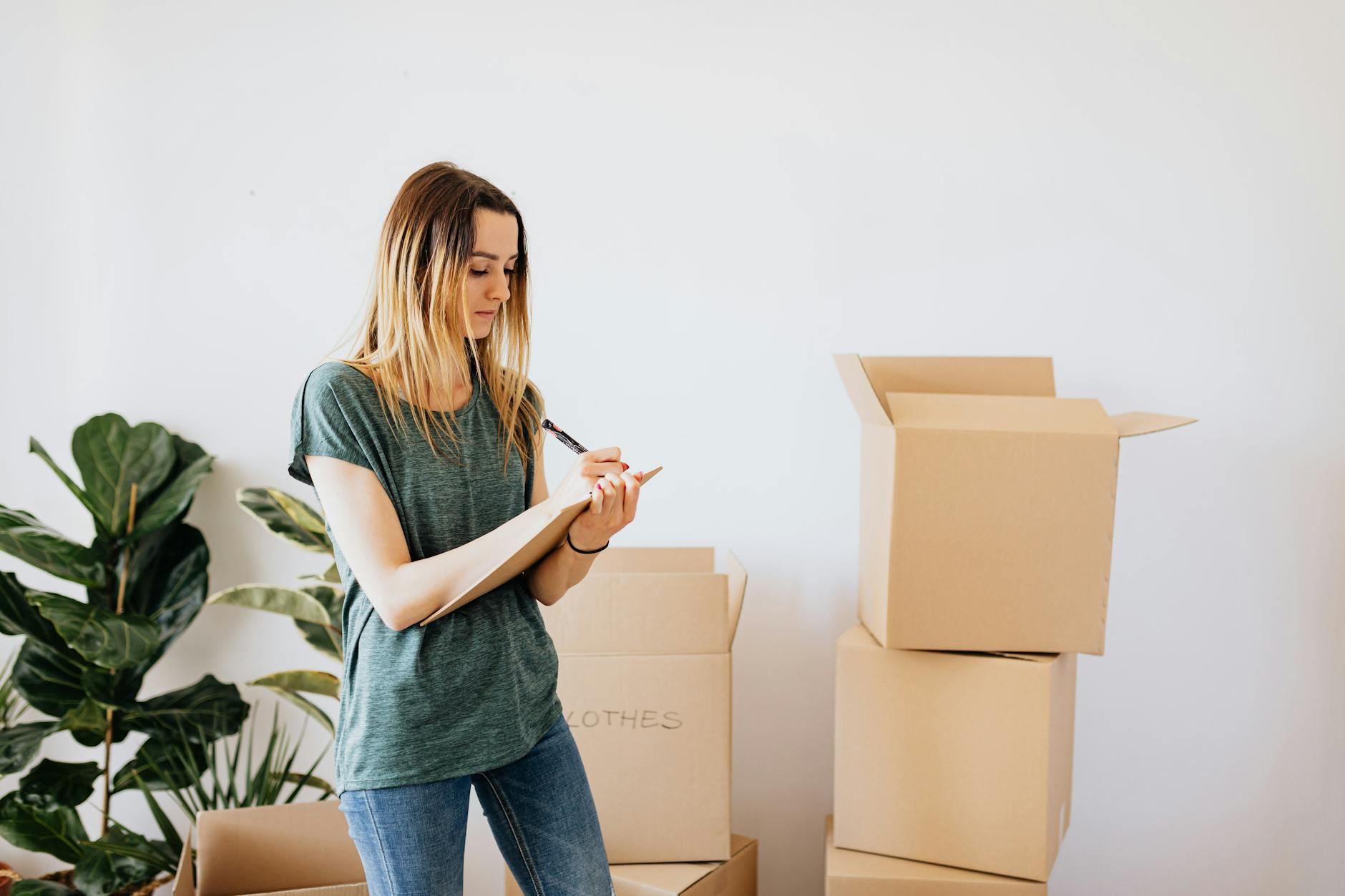 Checklist and labeled moving boxes in a calm apartment prepared for relocation