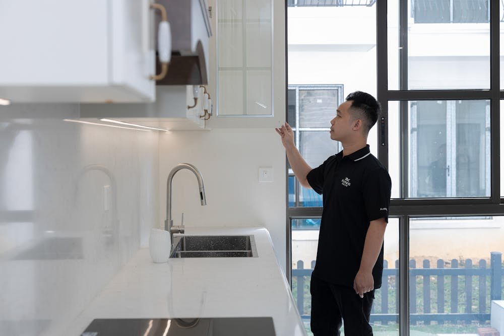 Person inspecting a modern apartment kitchen before estimating cleaning scope.