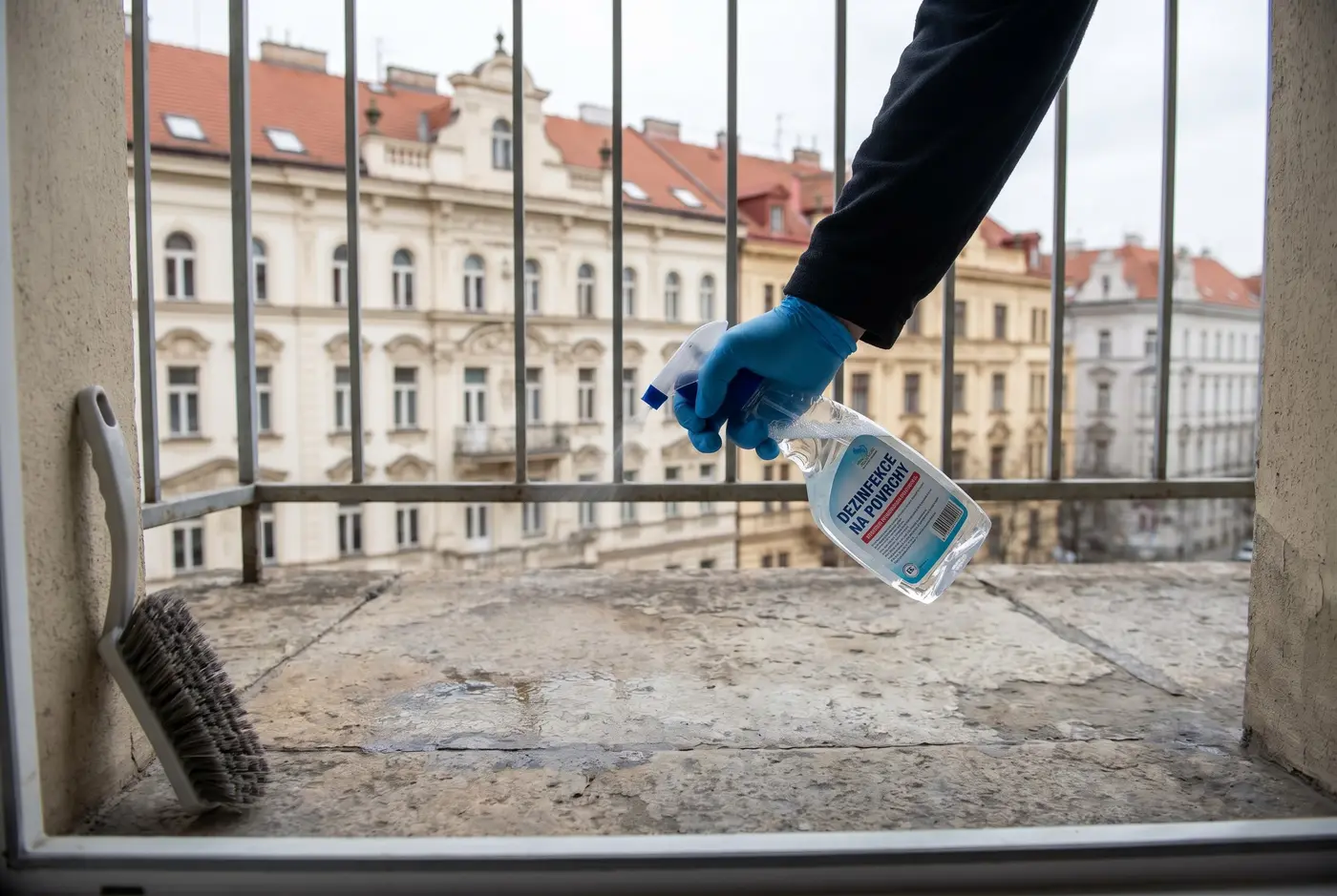 Applying disinfectant on a balcony after removing pigeon droppings